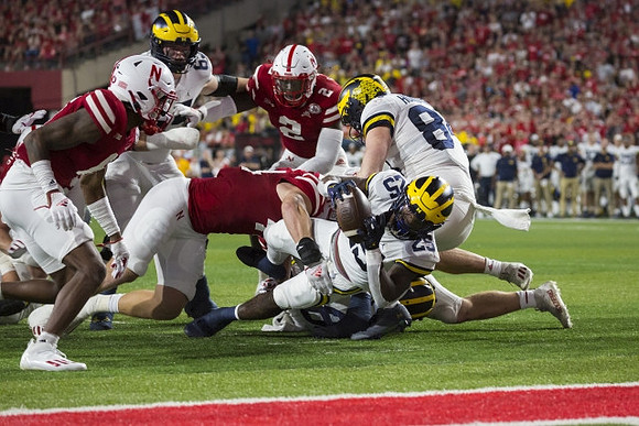 Hassan Haskins (25) and Joel Honigford (84)