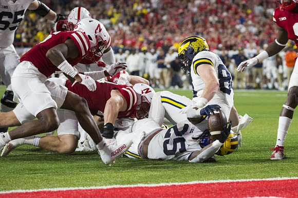 Zak Zinter (65), Hassan Haskins (25), and Joel Honigford (84)