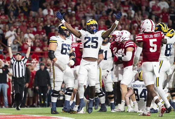 Zak Zinter (65), Hassan Haskins (25), Andrew Stueber (71), and Joel Honigford (84)