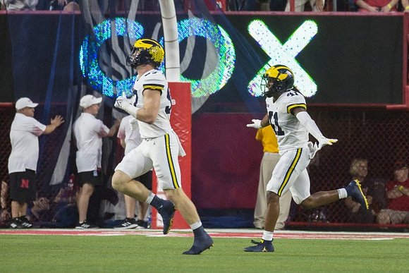 Aidan Hutchinson (97) and Nikhai Hill-Green (41)