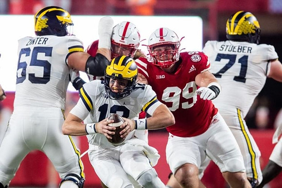 Zak Zinter (65), Blake Corum (2), and Andrew Stueber (71)