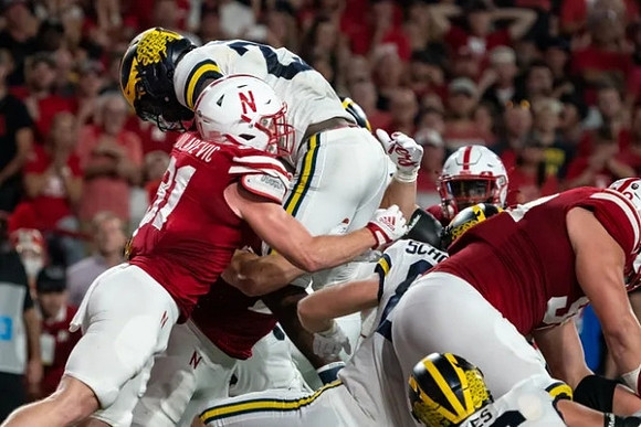 Hassan Haskins (25), Luke Schoonmaker (86), and Ryan Hayes (76)