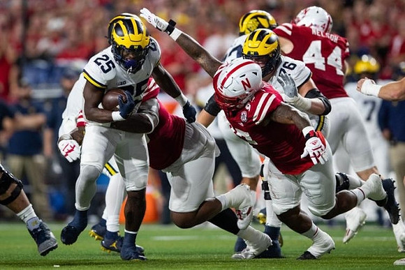 Hassan Haskins (25) and Ryan Hayes (76)