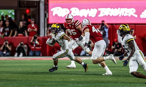 Blake Corum (2) and Mike Sainristil (5)