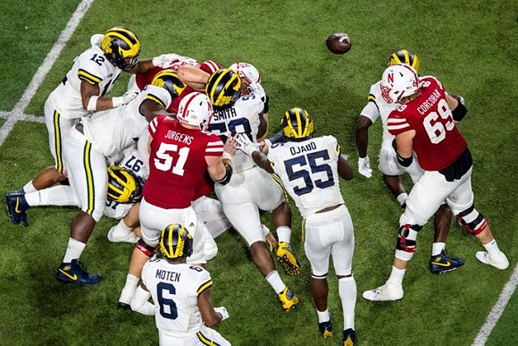 Josh Ross (12), Aidan Hutchinson (97), Mazi Smith (58), R.J. Moten (6), and David Ojabo (55)