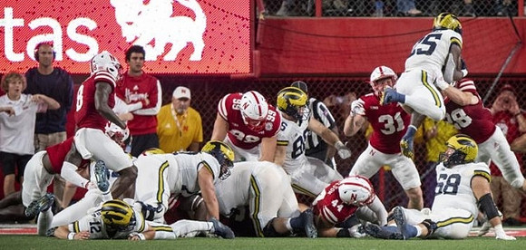 Cade McNamara (12), Luke Schoonmaker (86), Hassan Haskins (25), and Andrew Vastardis (68)
