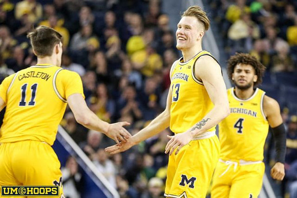 Colin Castleton (11), Ignas Brazdeikis (13), and Isaiah Livers (4)