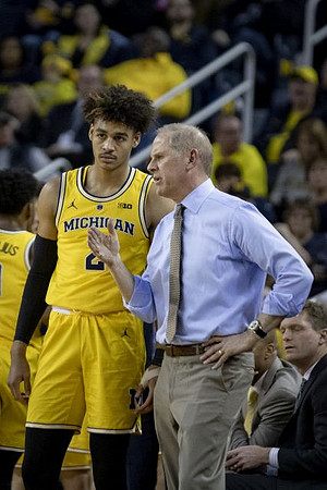 Jordan Poole (2) and John Beilein