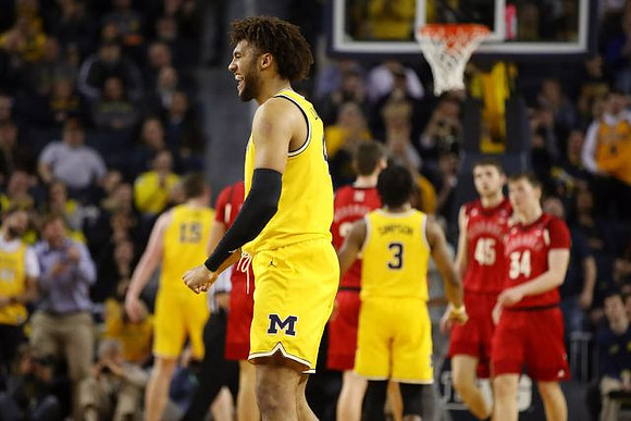 Isaiah Livers (4), Jon Teske (15), and Zavier Simpson (3)