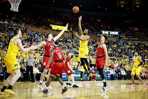 Jon Teske (15), Zavier Simpson (3), and Isaiah Livers (4)