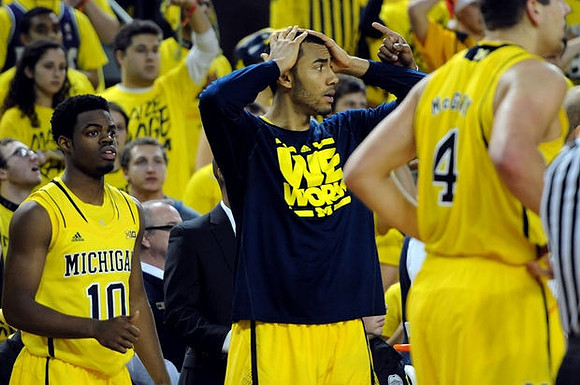 Derrick Walton Jr. (10), Jon Horford (15), and Mitch McGary (4)