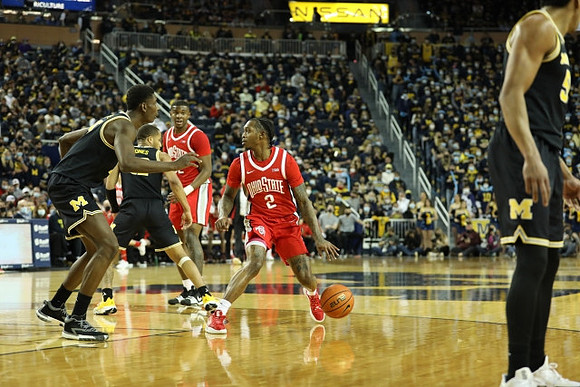 Moussa Diabate (14), DeVante' Jones (12), and Eli Brooks (55)