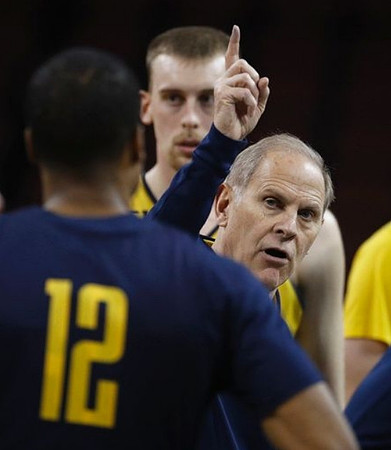 Austin Davis (51), Muhammad-Ali Abdur-Rahkman (12), and John Beilein