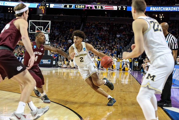 Jordan Poole (2) and Duncan Robinson (22)