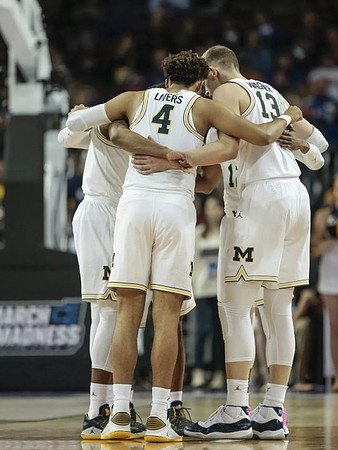 Isaiah Livers (4), Moritz Wagner (13), and Michigan Team