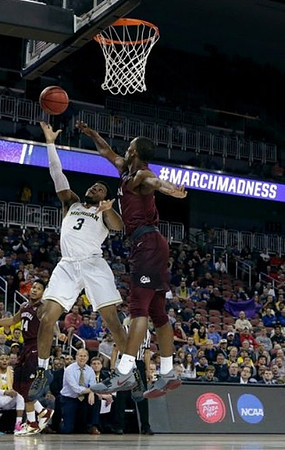 Zavier Simpson (3) and John Beilein