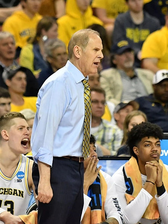 Moritz Wagner (13), John Beilein, and Ibi Watson (23)