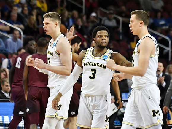 Moritz Wagner (13), Zavier Simpson (3), and Duncan Robinson (22)