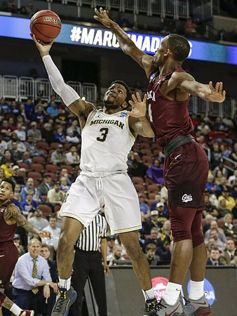 Zavier Simpson (3) and John Beilein