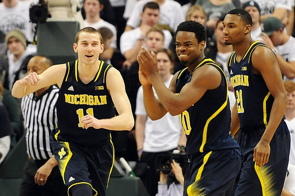 Nik Stauskas (11), Derrick Walton Jr. (10), and Zak Irvin (21)