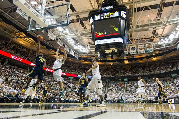 Derrick Walton Jr. (10), Jordan Morgan (52), and Nik Stauskas (11)