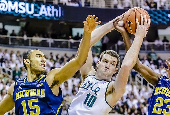 Jon Horford (15) and Caris LeVert (23)