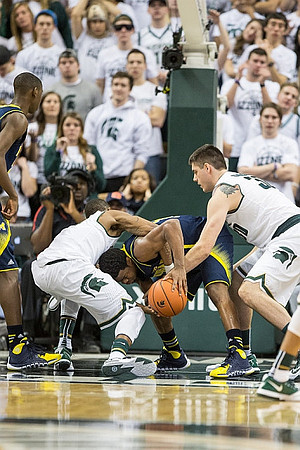 Derrick Walton Jr. (10) and Caris LeVert (23)