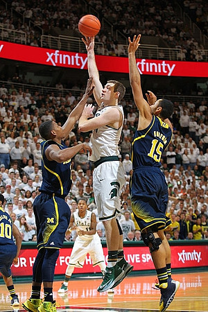 Derrick Walton Jr. (10), Glenn Robinson III (1), and Jon Horford (15)