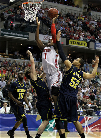 Tim Hardaway Jr. (10),  Zack Novak (0), and Jordan Morgan (52)