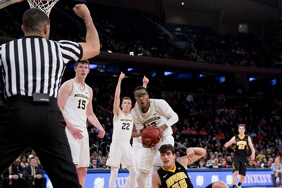 Jon Teske (15), Duncan Robinson (22), and Muhammad-Ali Abdur-Rahkman (12)
