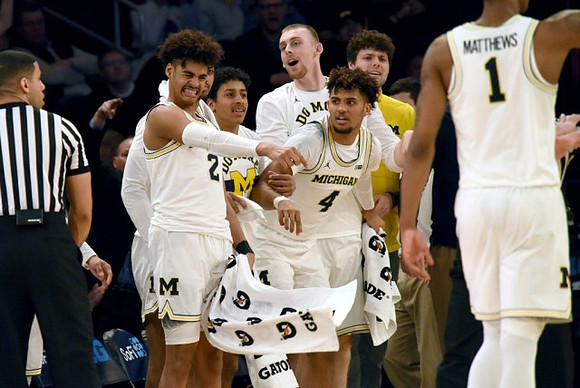 Charles Matthews (1) and Michigan Team