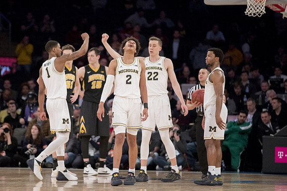 Charles Matthews (1), Jordan Poole (2), Duncan Robinson (22), and Zavier Simpson (3)