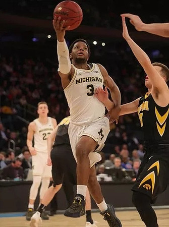Duncan Robinson (22) and Zavier Simpson (3)