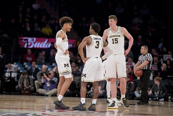 Jordan Poole (2), Zavier Simpson (3), and Jon Teske (15)
