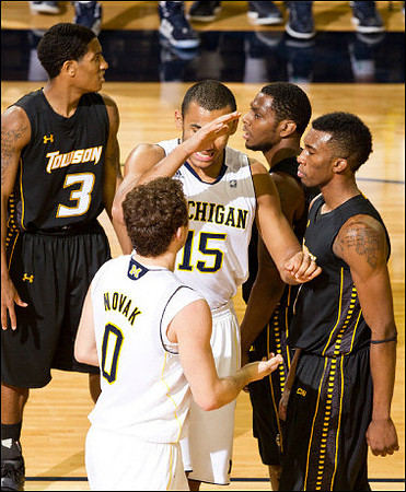 Zack Novak (0) and Jon Horford (15)