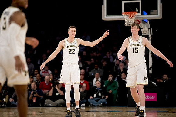 Zavier Simpson (3), Duncan Robinson (22), and Jon Teske (15)