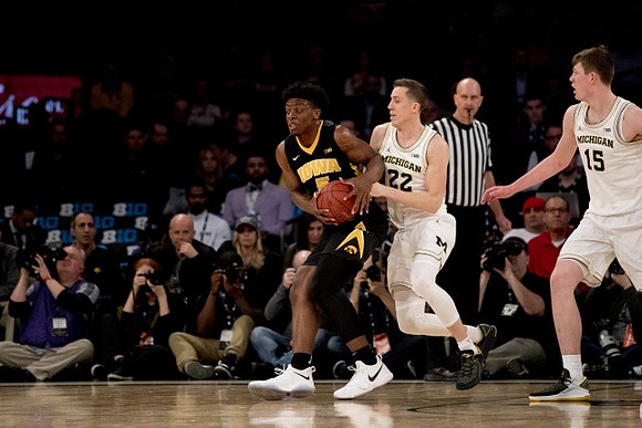 Duncan Robinson (22) and Jon Teske (15)