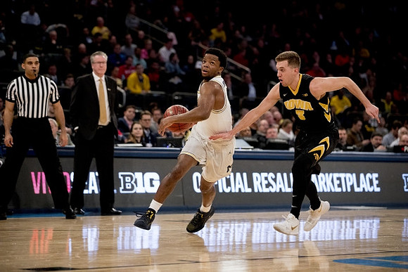 Zavier Simpson (3) and Iowa Head Coach Fran McCaffery
