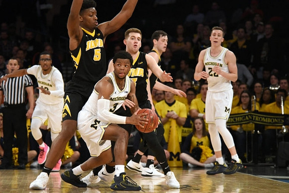Muhammad-Ali Abdur-Rahkman (12), Zavier Simpson (3), and Duncan Robinson (22)