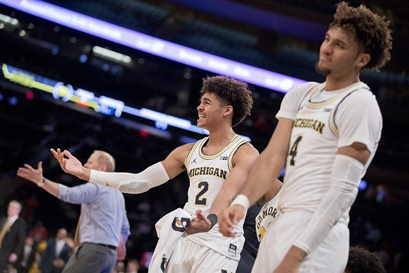 John Beilein, Jordan Poole (2), and Isaiah Livers (4)