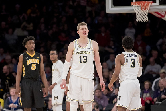 Muhammad-Ali Abdur-Rahkman (12), Moritz Wagner (13), and Zavier Simpson (3)