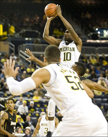 Jordan Morgan (52), Tim Hardaway Jr. (10), and Trey Burke (3)