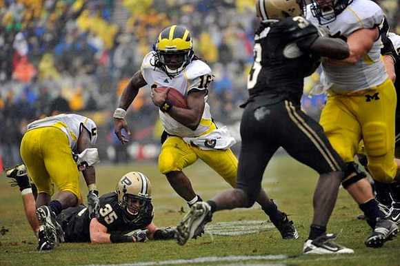 Vincent Smith (2) and Denard Robinson (16)