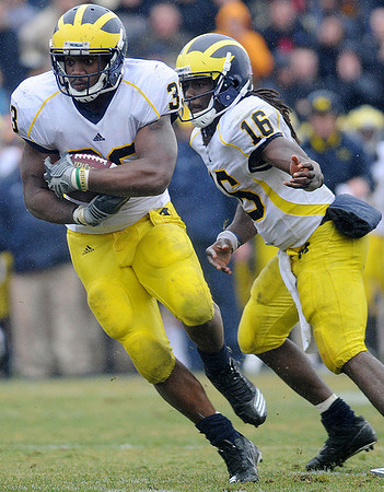 Stephen Hopkins (33) and Denard Robinson (16)