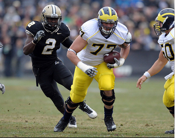 Taylor Lewan (77) and David Molk (50)
