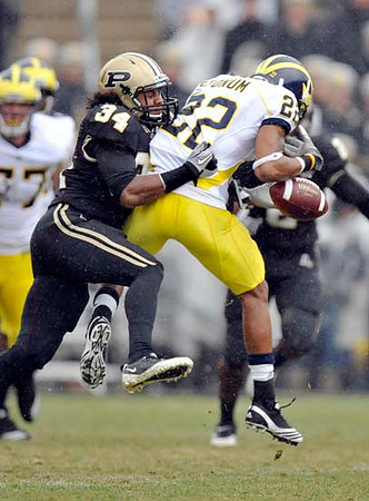 Darryl Stonum (22) and Taylor Lewan (77)