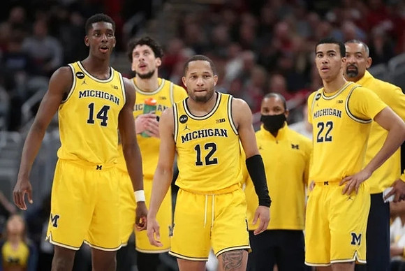 Moussa Diabate (14), Brandon Johns Jr. (23), DeVante' Jones (12), Caleb Houstan (22), and Juwan Howard