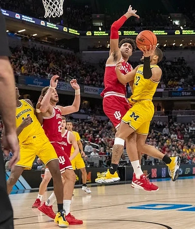 DeVante' Jones (12), Moussa Diabate (14), and Caleb Houstan (22)
