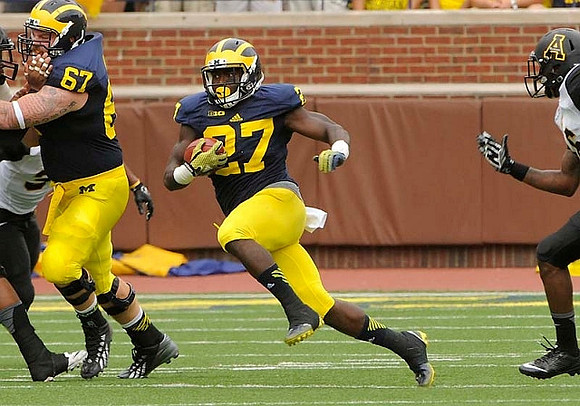 Kyle Kalis (67) and Derrick Green (27)