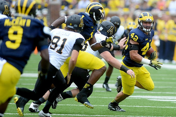 Mike McCray (9), Devin Funchess (1), and Ben Gedeon (42)